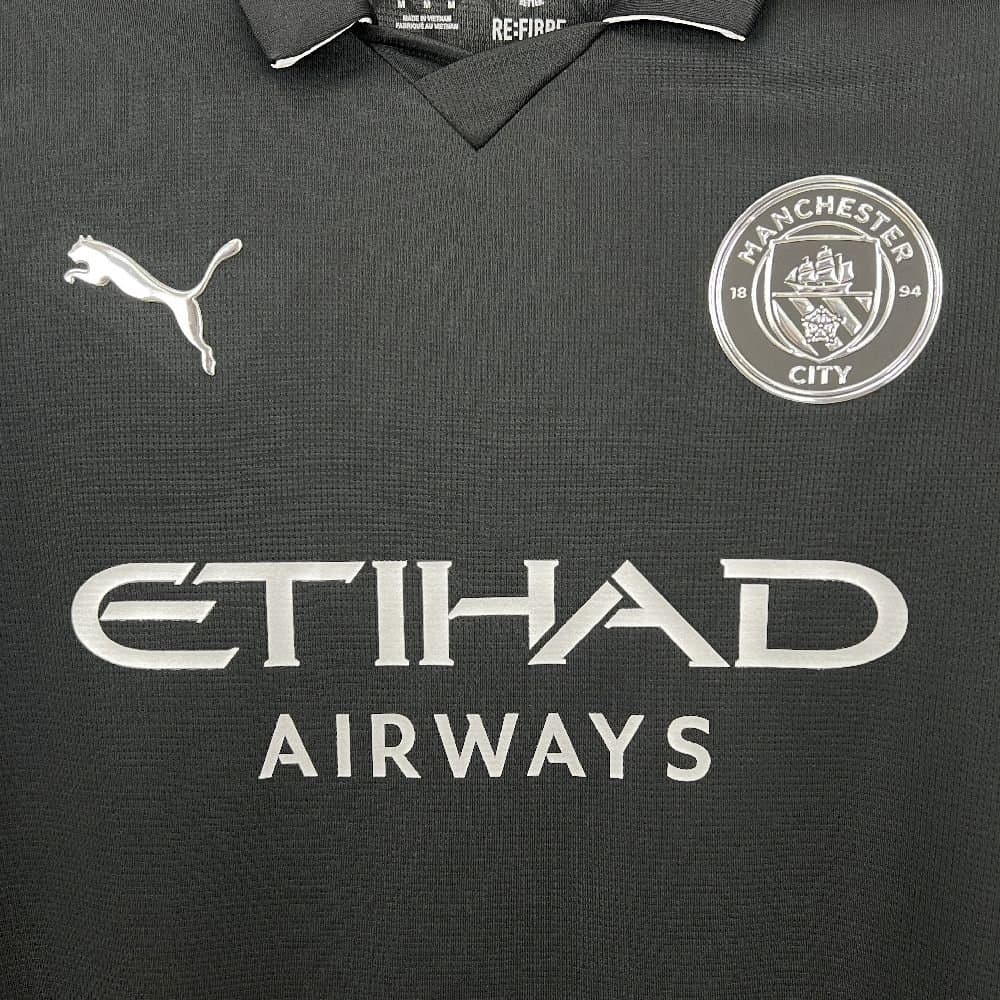 Man. City 2025/26 2a Eq. — vista trasera